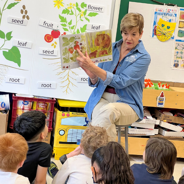 Extension Master Gardener teaching youth in a classroom about plant parts and how plants grow